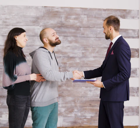 real estate agent business suit giving keys young couple after signing document couple becoming homeowners